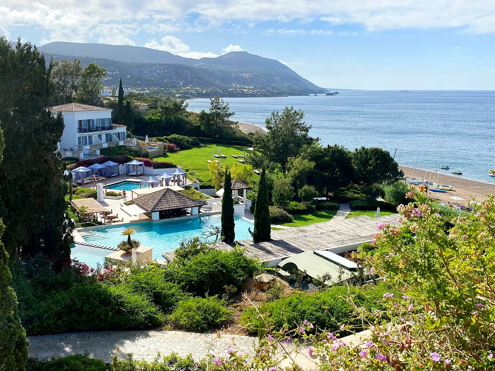 An aerial view of a Cyprus coastal resort with gardens, pools and the sea beyond
